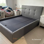 Gray upholstered bed with tufted headboard in a room setting, featuring 'dunepine.com' branding.